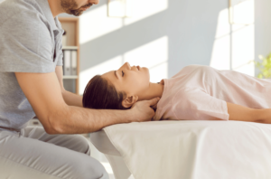 A chiropractor treating a woman with neck pain